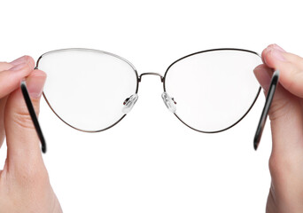 Woman holding stylish glasses with metal frame on white background, closeup