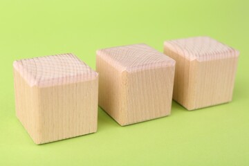 International Organization for Standardization. Wooden cubes with abbreviation ISO on light green background, closeup