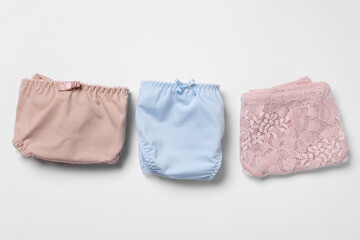 Stylish folded women's underwear on white background, flat lay