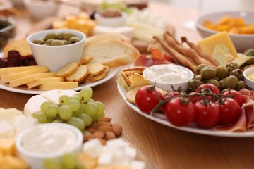Assorted appetizers served on wooden table, closeup
