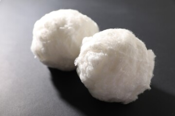 Balls of clean cotton wool on grey background, closeup