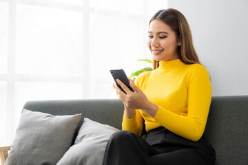 Close up of woman's hands holding credit card and smartphone and laptop Young woman pays online using bank, enters order information in internet shop, online name concept