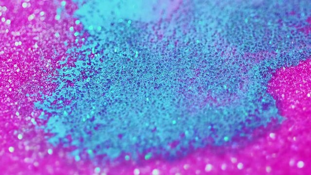 Abstract background. Sparkles fluid. Glitter bath. Glamorous hypnotic shiny aromatherapy blue and pink bomb dissolving spreading in spa water.