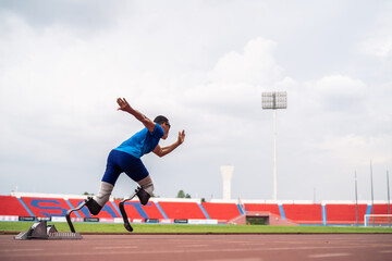 Asian athletes are disabled with prosthetic blades running at stadium.  - Powered by Adobe