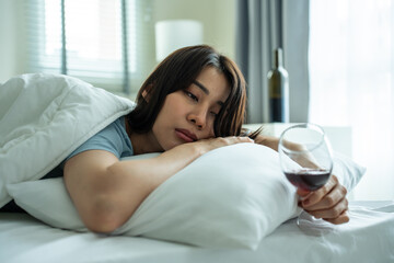 Obraz na płótnie Canvas Asian young depression woman feeling heart broken and drinking alcohol. 