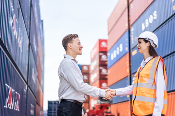 Caucasian businesswoman and businessman worker work in container port.