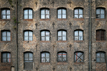 Facade of an old abondoned building boarded up windows , old brick building