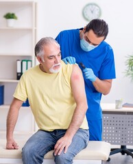 Injured old man visiting young male doctor traumatologist