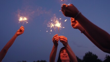 Sparkler party. Girls have fun in nature with sparklers. Bengali flicker. Fun party with bright...