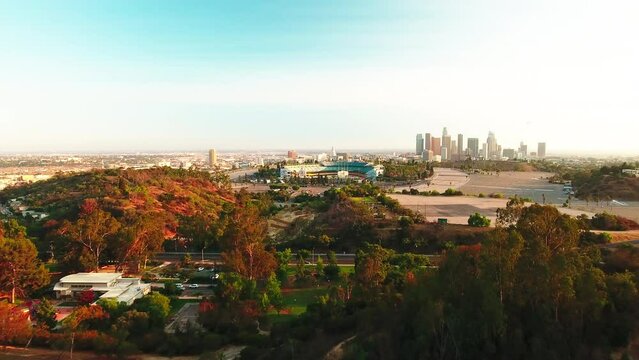 Aerial Forward Shot Of Trees Near Dodger Stadium And Downtown In City Against Sky - Los Angeles, California