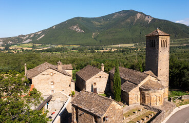 Fototapeta na wymiar Aerial view of bell tower and apse of the Mozarab Pre-Romanesque or Romanesque Church of San Pedro de Larrede in the Serrablo Region. Aragon. Spain