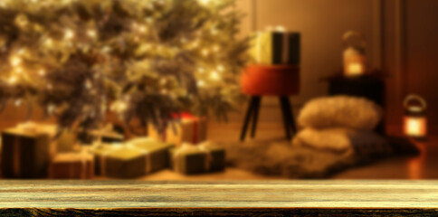 Empty wooden table in room with Christmas tree. Banner with space for design