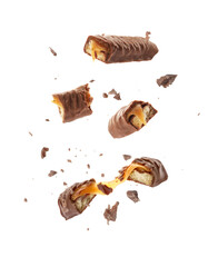 Pieces of chocolate bars with caramel falling on white background - obrazy, fototapety, plakaty