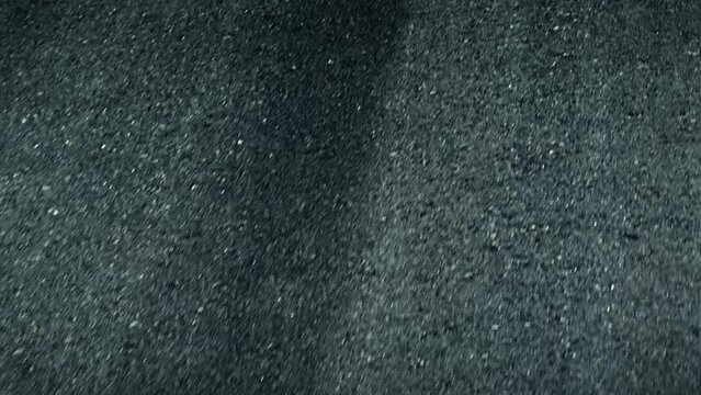 The recently laid asphalt road exhibits impeccable compaction as a car traverses its flawless surface, showcasing the precision of modern road construction techniques. Vehicle concept.
