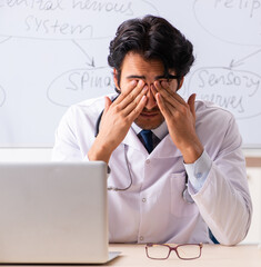 Young male doctor neurologist in front of whiteboard