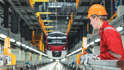 Electric train technician engineer checking controls system for security functions in maintenance infrastructure plant of sky train, public transportation vehicle,Teamwork management concept.