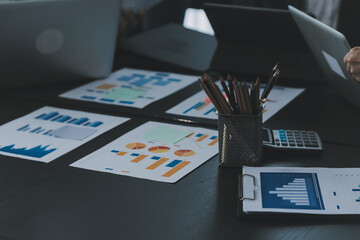 Close up of Business team analyzing income charts and graphs with modern laptop computer. Business analysis and strategy concept.