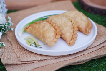 Curry puff or Pastel Goreng is Pastry Popular in Indonesia. fried pastry with filling of sauted vegetable, chicken and boiled egg. accompanied with  sauce or raw chilli pepper