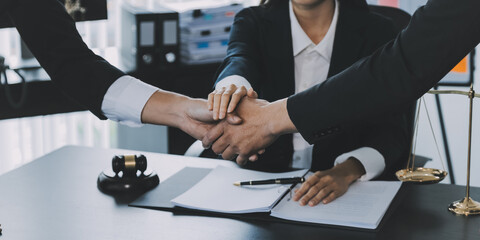 Businessman shaking hands to seal a deal with his partner lawyers or attorneys discussing a contract agreement