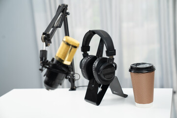 All stuff sets of live streaming standing on white desk consist of microphone, headsets, coffee...