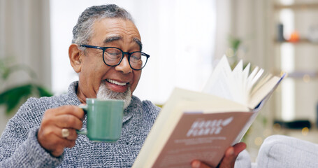 Senior man, book and coffee on sofa with smile, reading or relax in retirement in home living room....