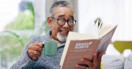 Elderly man, book and coffee on sofa with smile, reading or relax in retirement in home living room. Senior african person, literature and happy with tea for knowledge, thinking and drink on couch - obrazy, fototapety, plakaty