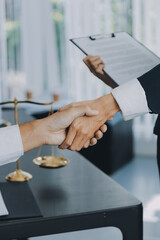 Businessman shaking hands to seal a deal with his partner lawyers or attorneys discussing a contract agreement