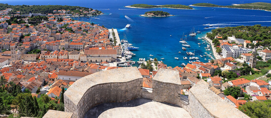 Panoramic aerial view of harbor of Hvar with Adriatic Sea and boats, Croatia