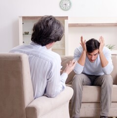 Young male patient discussing with psychologist personal problem