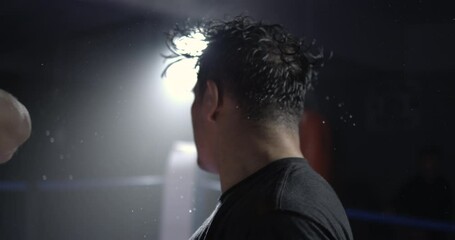 Man getting punched in the face in super Dramatic slow-motion at 800 fps impact with droplets of sweat flying in the air. Fighter getting hit - Powered by Adobe