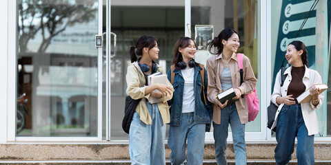 Group of Young Asian student walking and talking at university before class room. education, back...