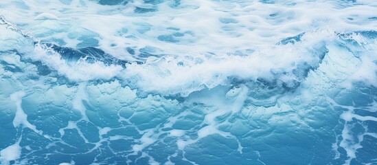 Fototapeta na wymiar Crashing waves generating foamy surface on the beach Detailed close up of deep blue ocean