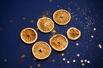 Dried orange slices on a blue background with stars.