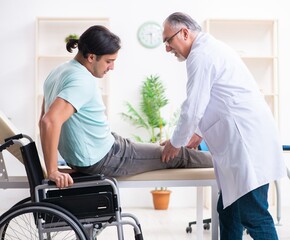 Obraz premium Male patient in wheel-chair visiting old doctor