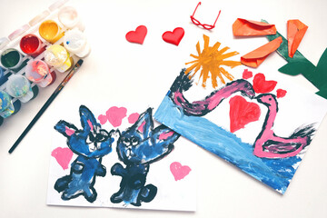 Child painting lovely cats, couple swan, hearts, making crafts from paper. Handmade concept for birthday, mothers day or Valentines day. Education. Inspiration and imagination