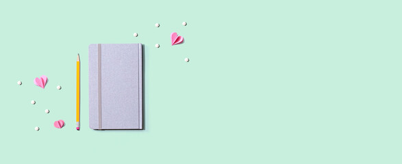 Gray notebook with paper hearts - flat lay