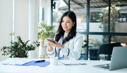 Asian businesswoman sit at their desks and calculate financial graphs showing results about their investments, planning a successful business growth process