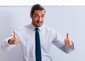 Young male employee in business presentation concept