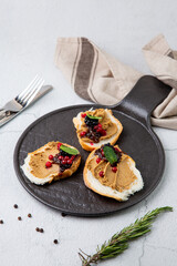 canapes with pate, mint leaves and berries, top view