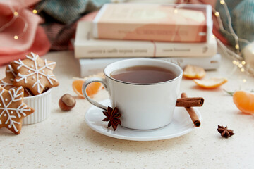 Cozy Christmas - aesthetic cup of coffee, gingerbread cookies, tangerines with books. Atmospheric holidays good mood