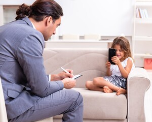 Child psychologist attending small girl