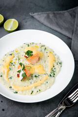 white rice porridge with herbs and fish, side view