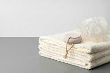 Fototapeta na wymiar Pumice stone and stacked towels in a bathroom