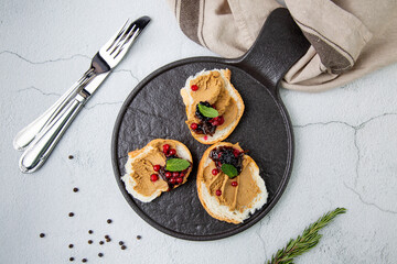 canapes with pate, mint leaves and berries, top view