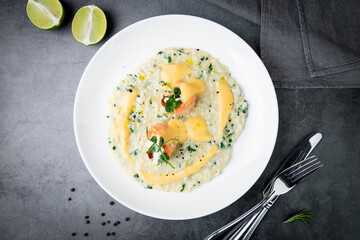 white rice porridge with herbs and fish, top view