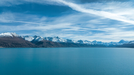 Drone  photograph of the shore of Lake pukaki  and the Snow capped Southern Alps peaks in the...