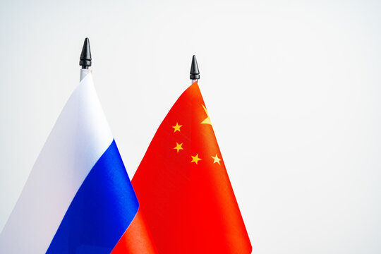 Russian and Chinese flags on negotiation table