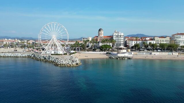 Ascending drone footage of the Ferris Wheel of Saint-Raphael in Cote d'Azur, France