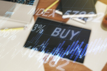 Abstract creative financial graph and modern digital tablet on desktop on background, top view,...