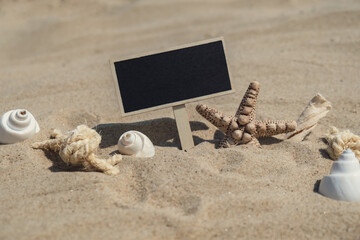 Empty blackboard frame board with copy space for your text or design displays on sandy beach....